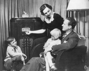 A family gathers around and old-timey radio set.